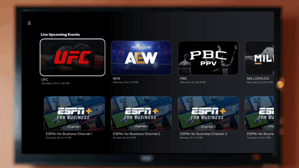 A TV screen displaying the Joe Hand Promotions app streaming interface, showing a “Live Upcoming Events” section with tiles for UFC, AEW, PBC PPV, Millions.co, and multiple ESPN+ for Business channels with their scheduled dates and times.